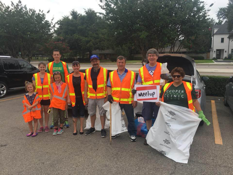 people in reflective vests doing community service work